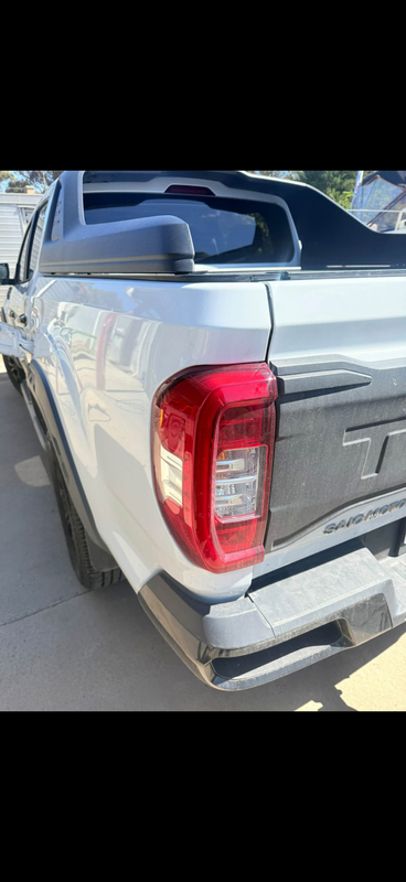 Rear of white ute, paint polished