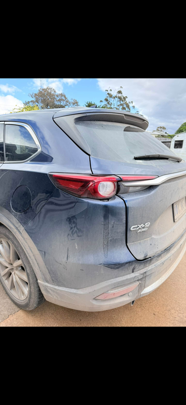 Blue Mazda CX-9 covered in road dust